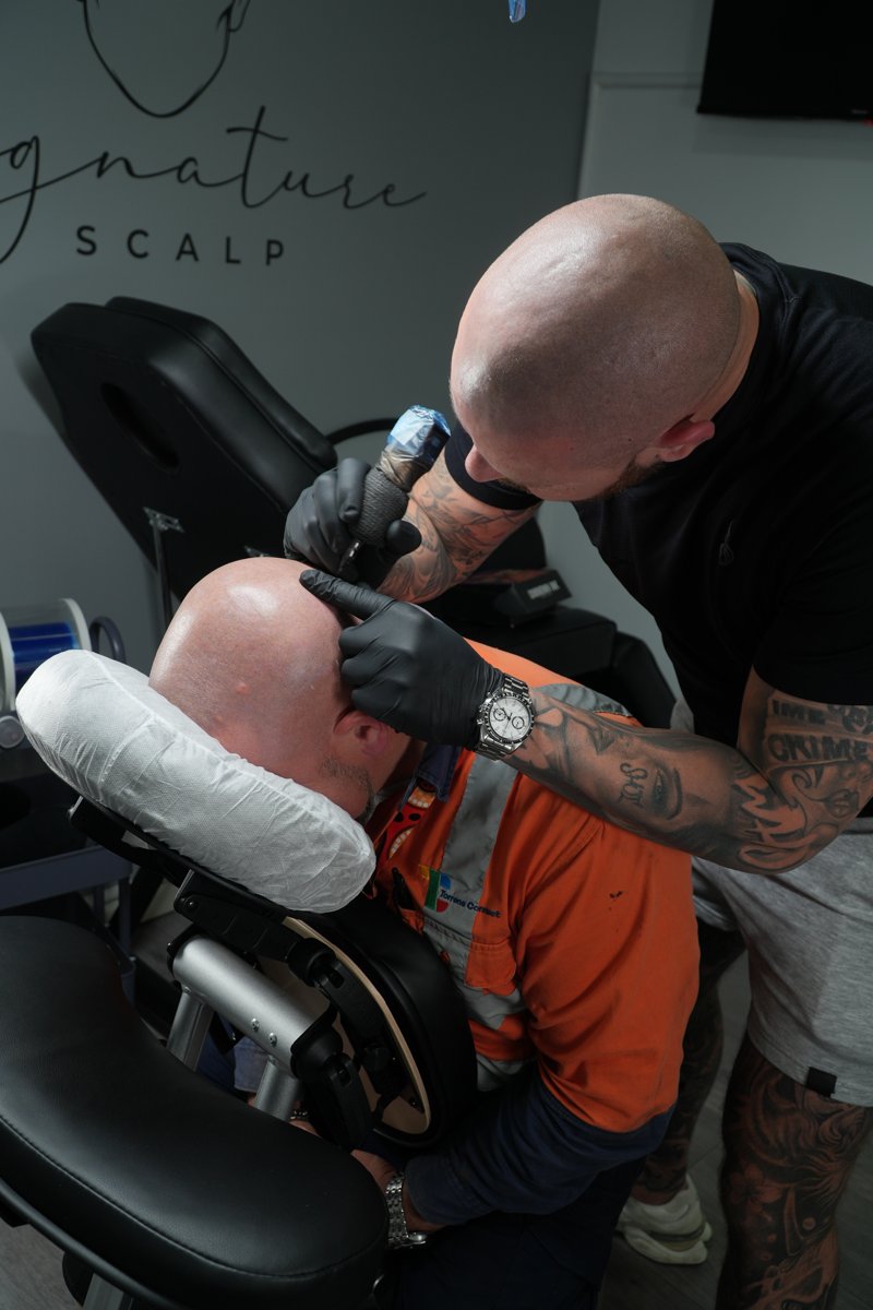 Michael performing scalp micropigmentation at the studio